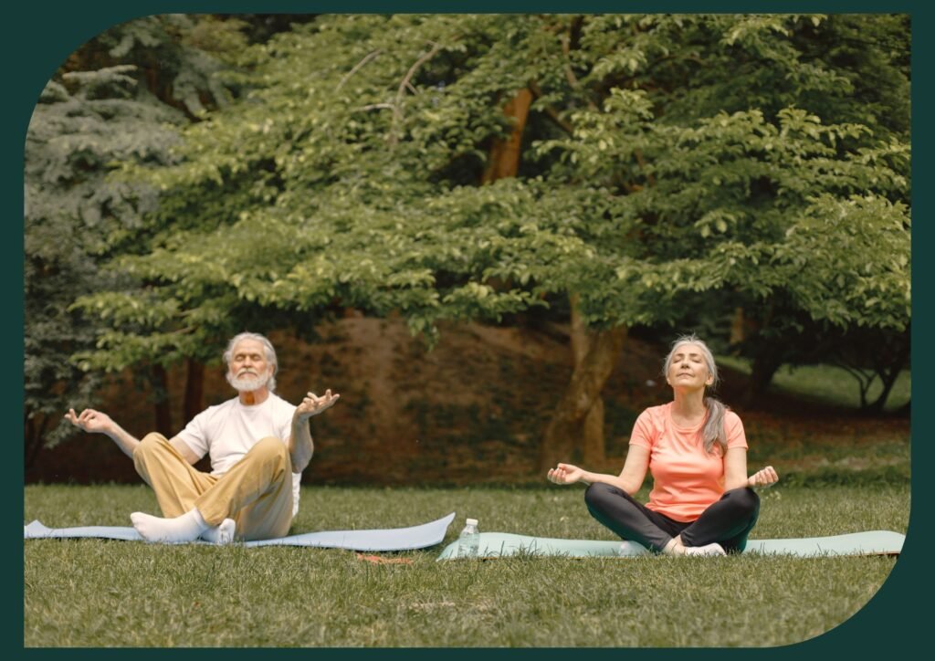 Seniors practicing yoga in a peaceful outdoor setting.