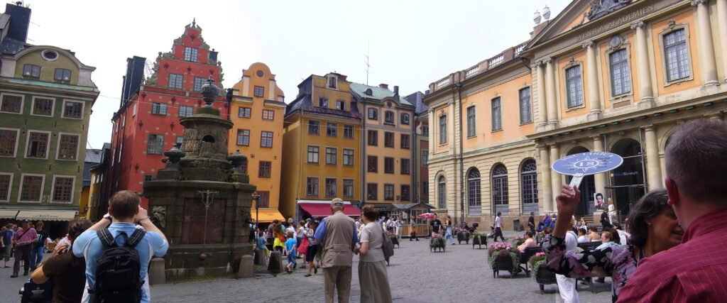 An image of tourists visiting senior Sweden travel spots.