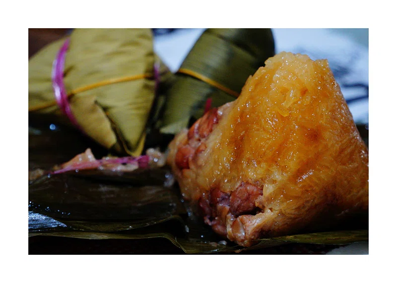 A closeup image of a tamales with meat filling. 