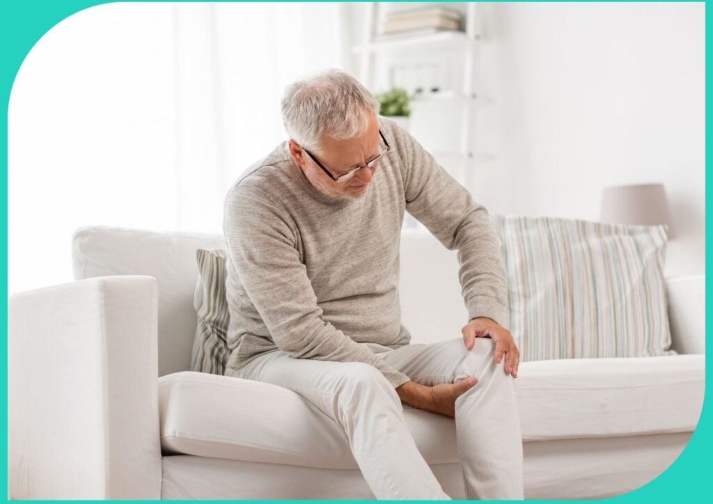 A senior sitting on a couch looking sad, representing the need for senior mobility aids