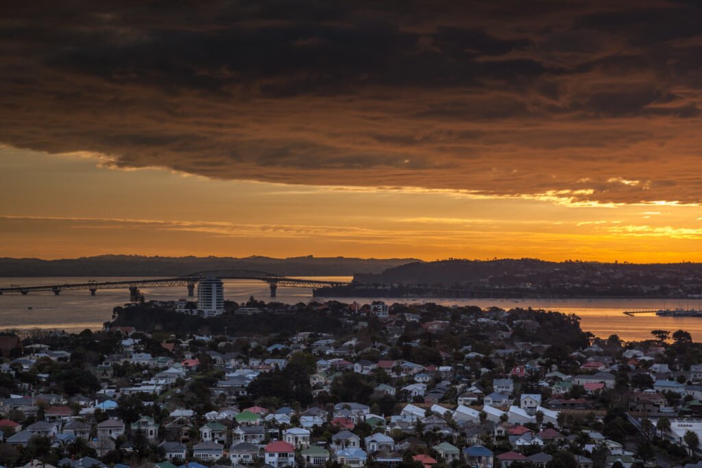 An image of the Waitemata Harbour with the sun setting.