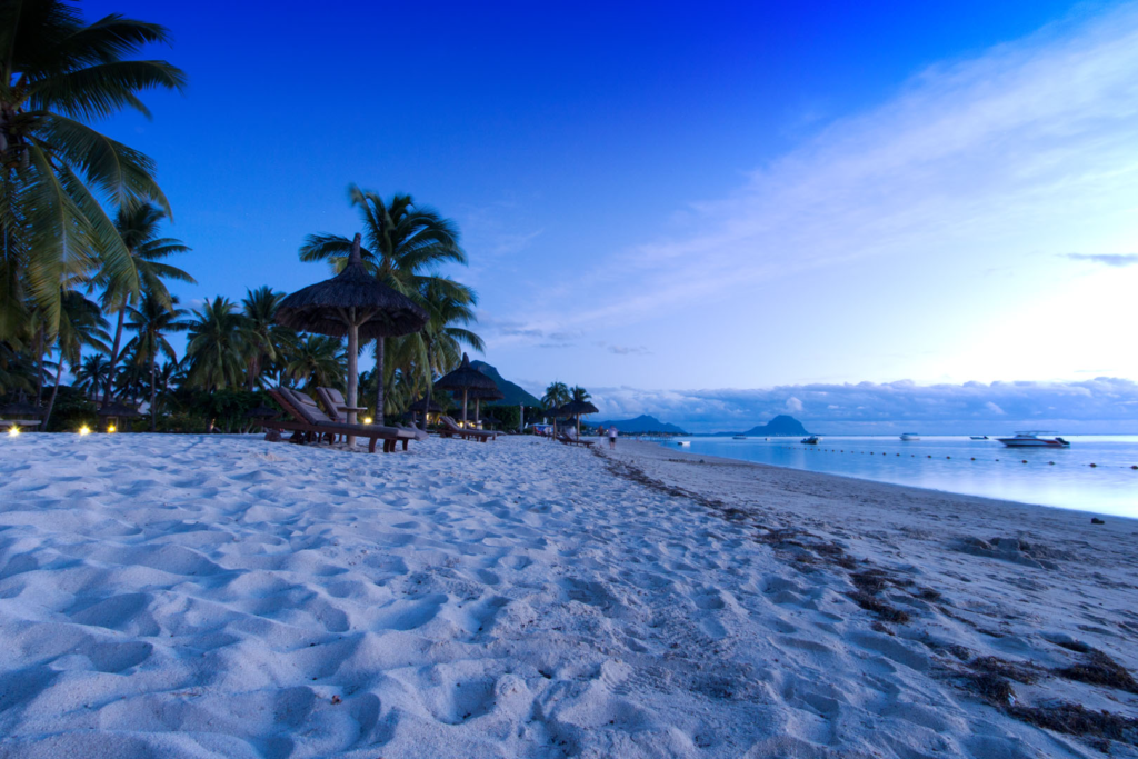 An image of a Flic en Flac beach while the sun is setting.