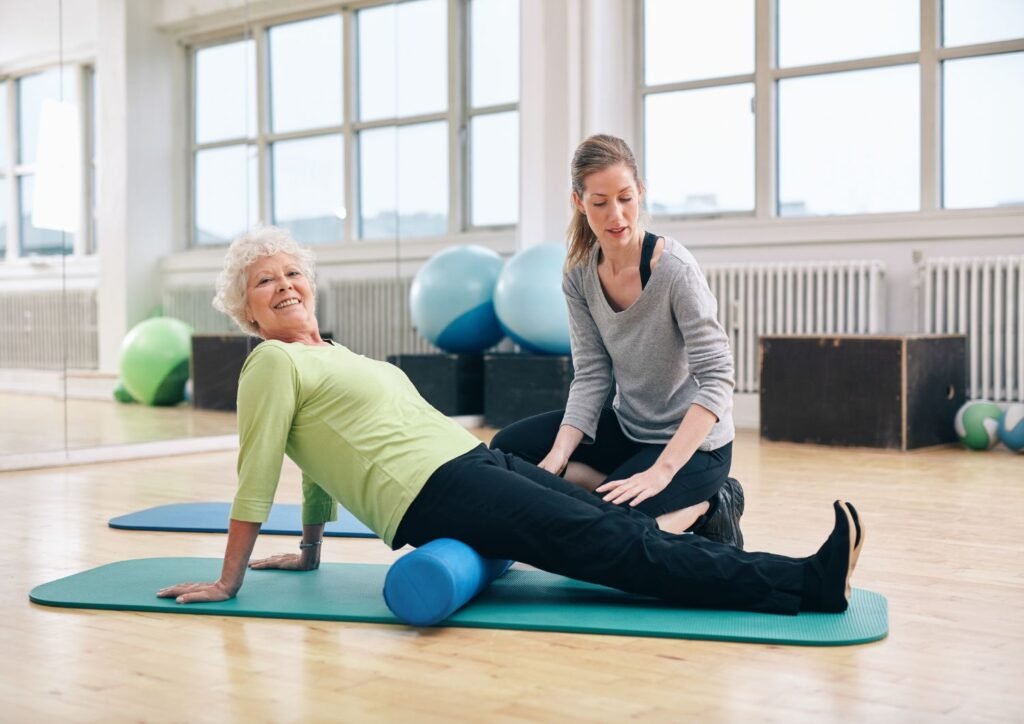 Senior Woman Doing Pilates with Foam Roller