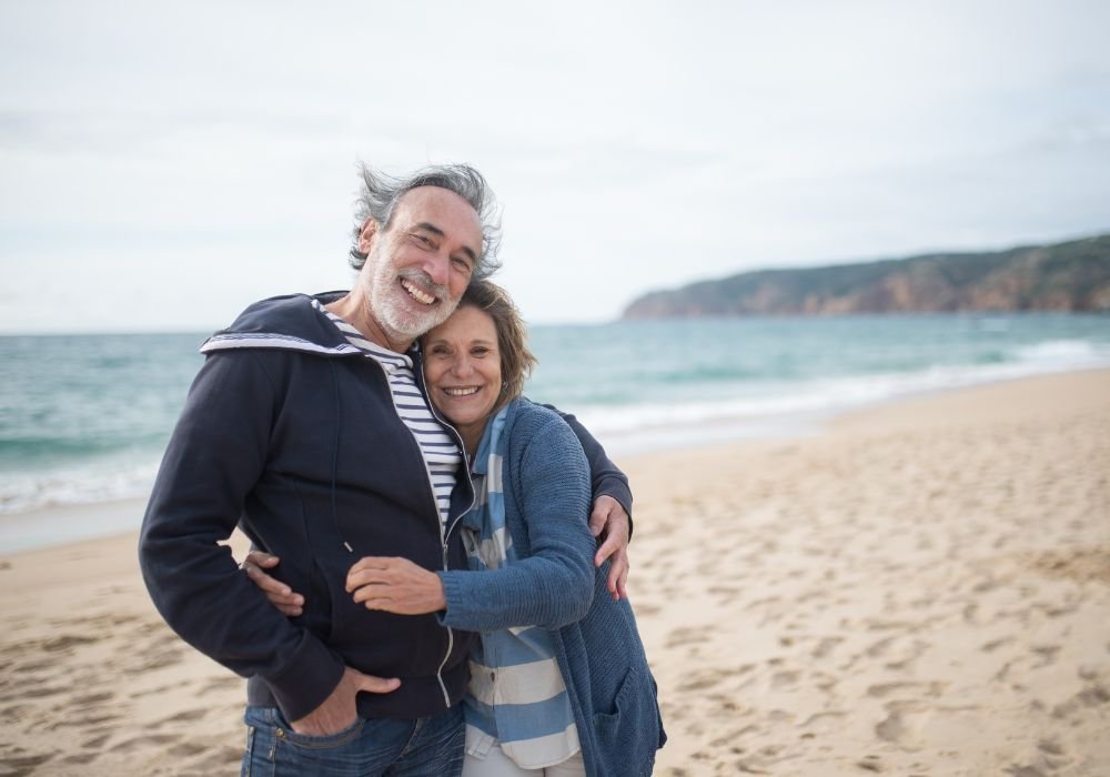 an image of a retired couple on a trip to the beach. 