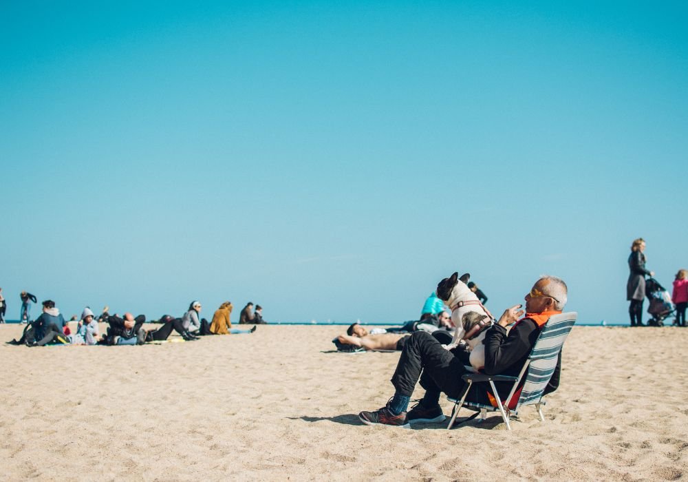 An image of a senior man relaxing on a beach. 