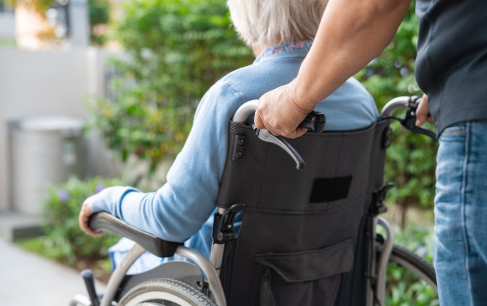 An image of a retiree on a wheelchair. 