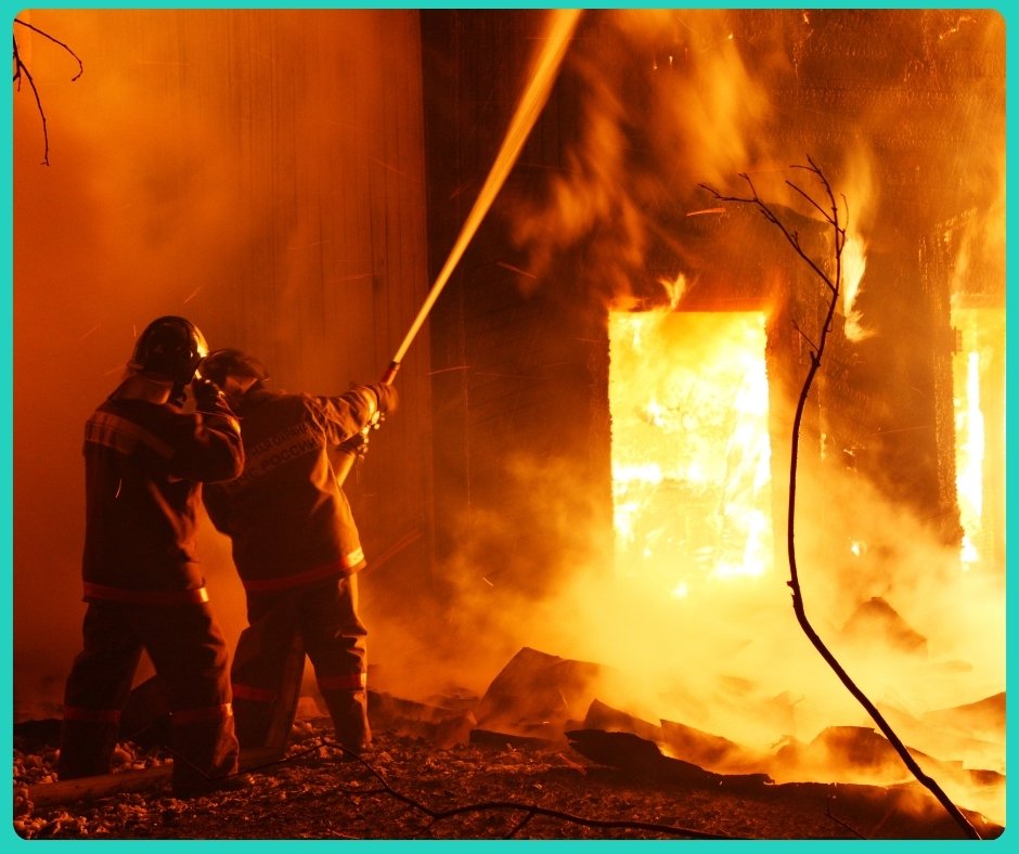 two fire fighters trying to safe a burning home