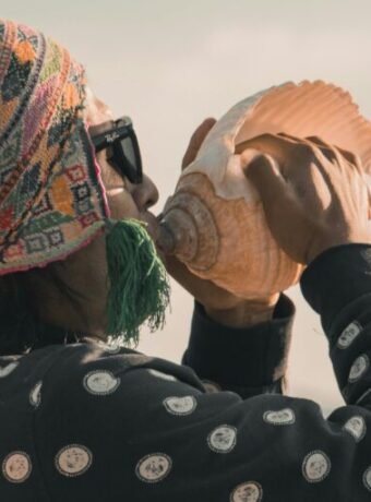 Man blowing on a conch shell