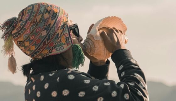 Man blowing on a conch shell