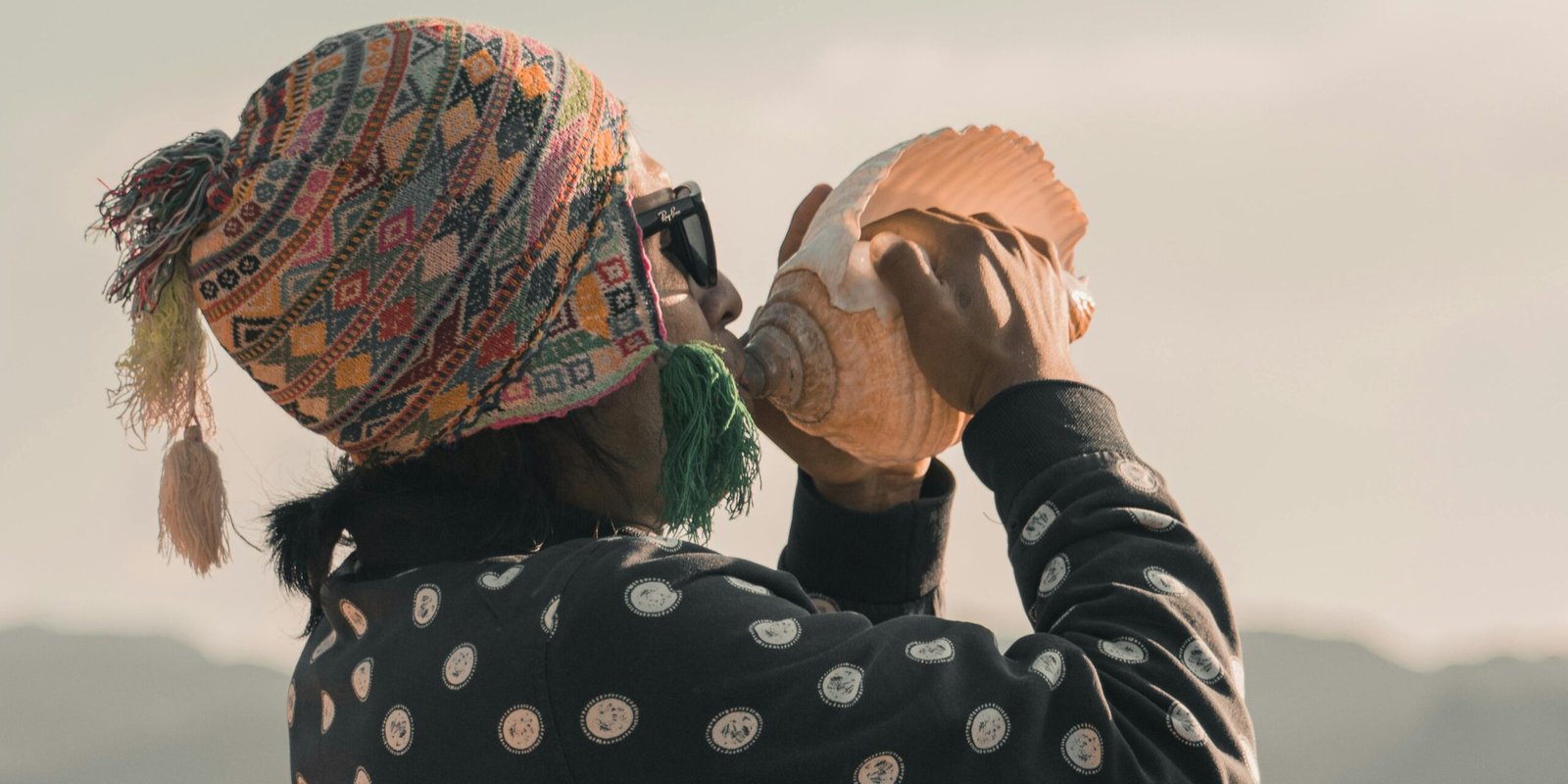 Man blowing on a conch shell