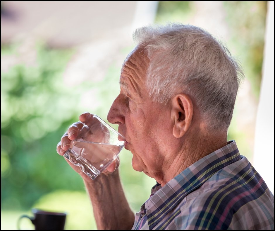 An image of a senior drinking a glass of water