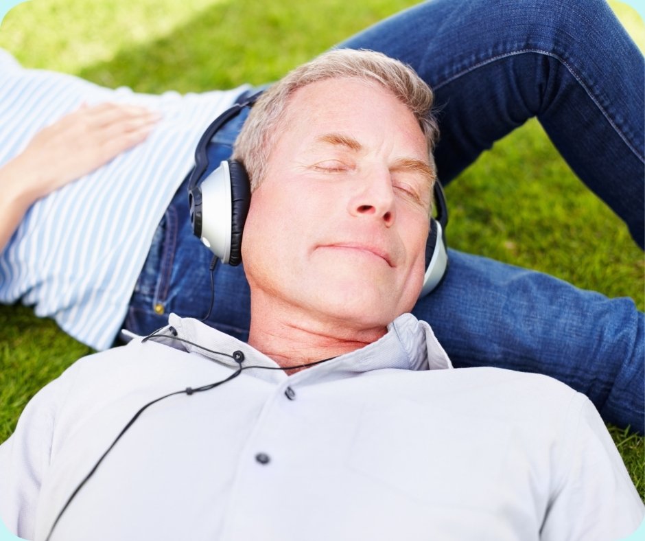 Relaxed senior man listening to music through headphones