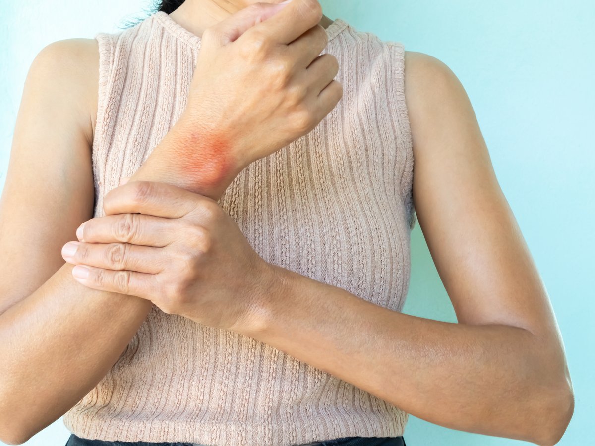 Young woman experiencing arthritic pain in her wrist